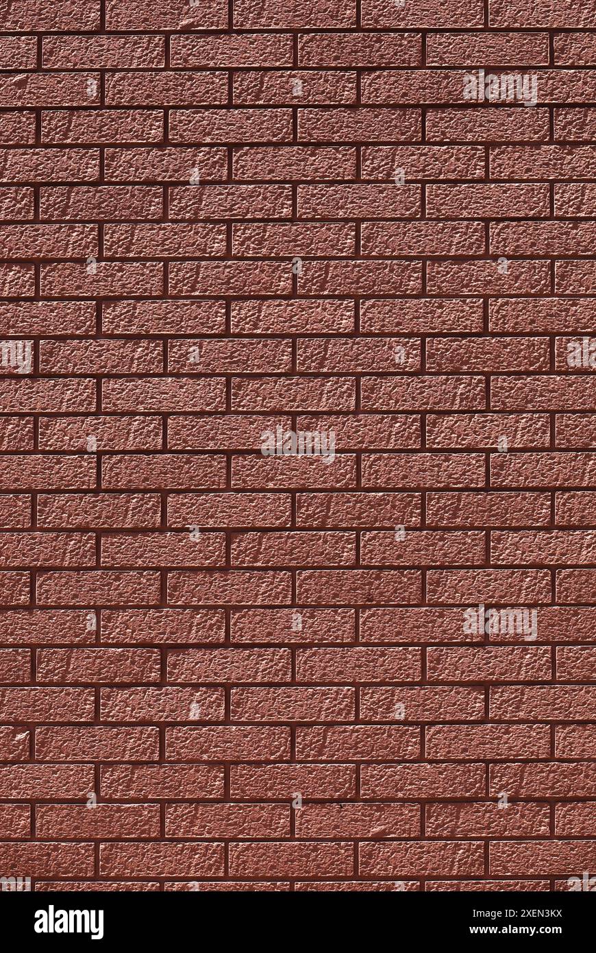 Una foto di un muro di mattoni rossi come materiale di sfondo Foto Stock