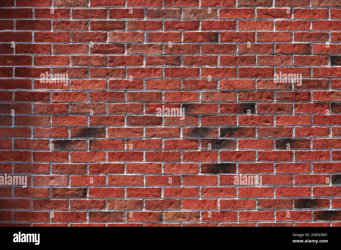 Una foto di un muro di mattoni rossi come materiale di sfondo Foto Stock