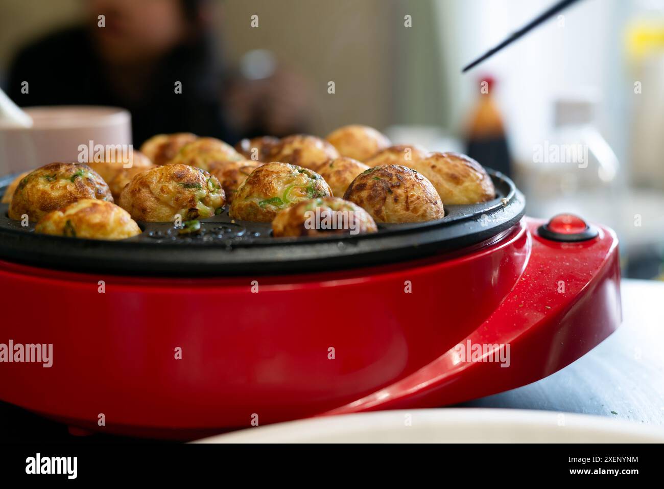 Takoyaki fatto in casa con un produttore takoyaki Foto Stock