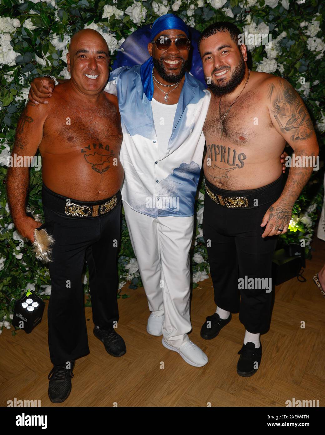 Kule T, Stavros Flatley e Michalis 'Lagi' Demetriou partecipano al Lady Wimbledon's Big Fat Wimbledon Tennis Party che si tiene all'Efes Premium di Londra. Foto Stock