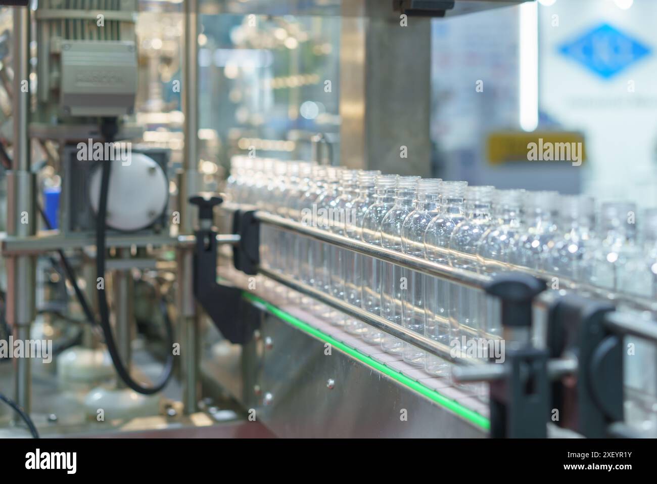 sistema di imbottigliamento automatizzato ad alta precisione al lavoro per riempire e tappare in modo efficiente i flaconi in un processo semplificato Foto Stock