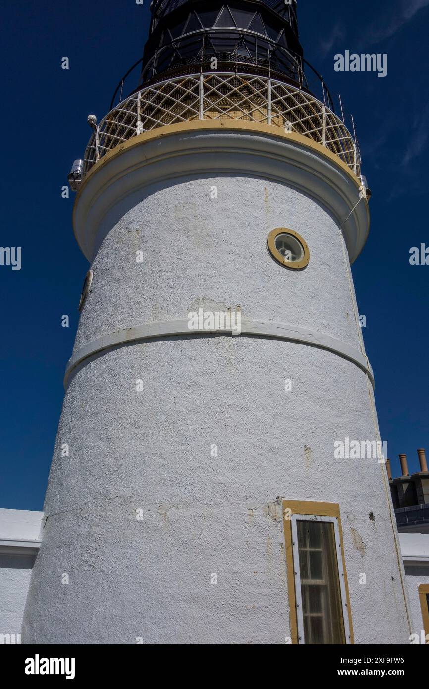 Faro bianco sotto un cielo azzurro, simboleggia la sicurezza marittima sulla costa, LERWICK, Scozia, Gran Bretagna Foto Stock
