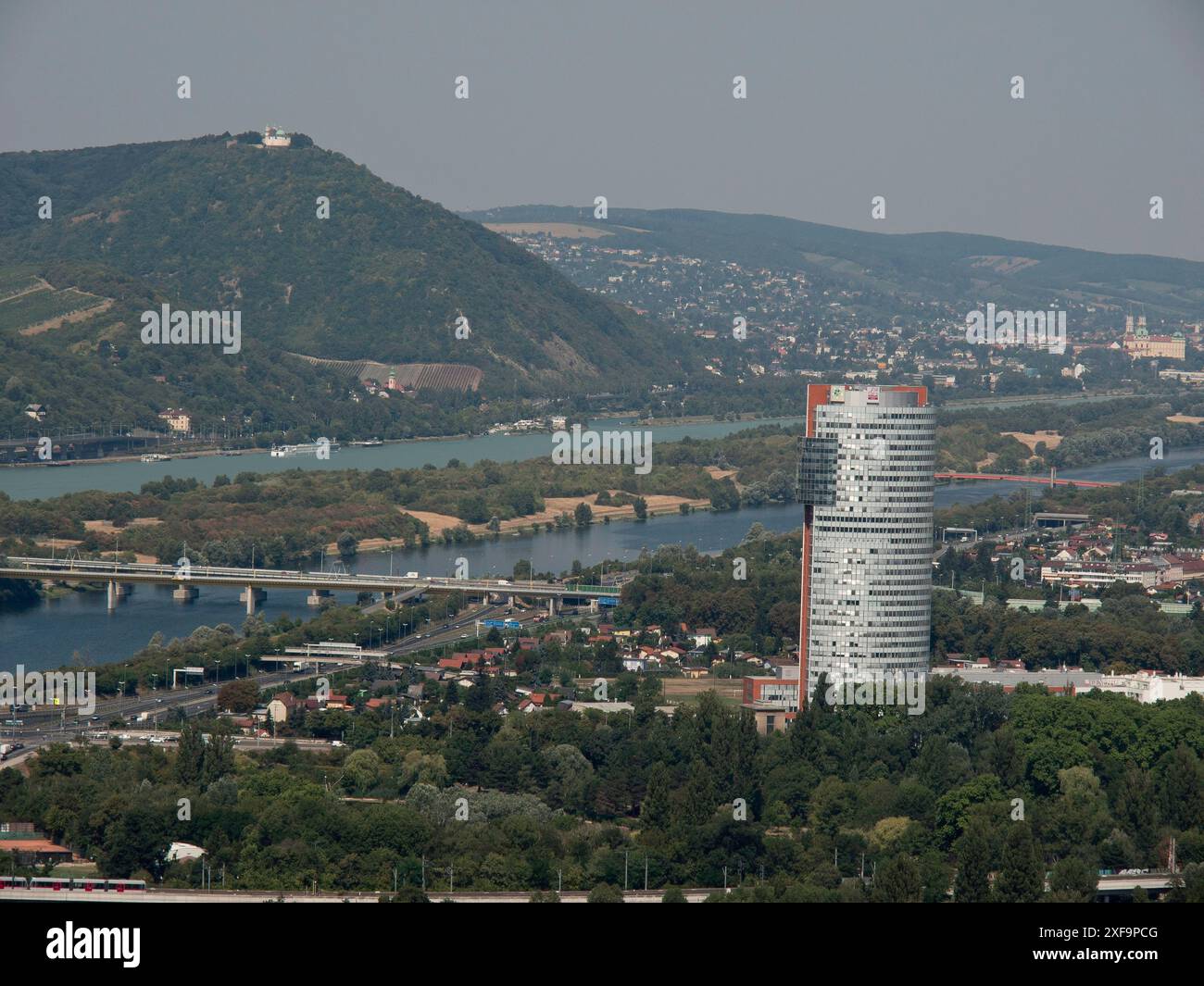 Panorama con grattacielo, fiume e paesaggi circostanti, tra cui montagne, Vienna, Austria Foto Stock