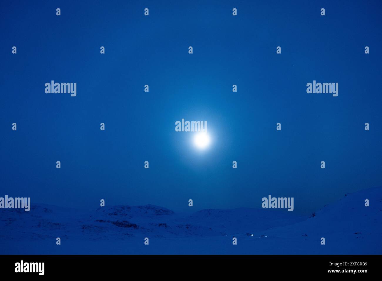 Finse, Norvegia -- luna piena luminosa su Finsevatnet ghiacciato in una fredda notte di gennaio Foto Stock