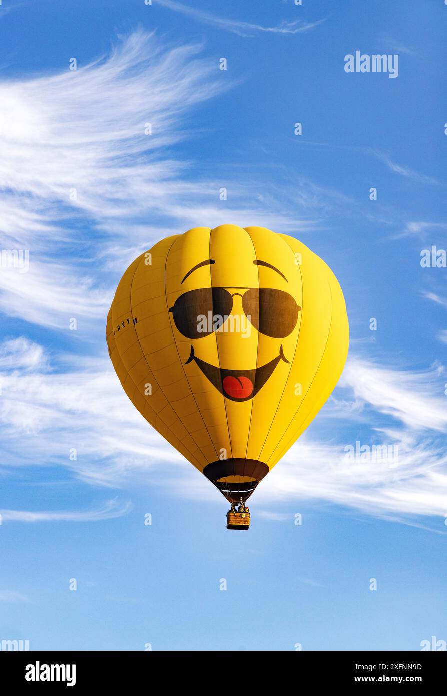 Pallone giallo ad aria calda con un volto con un grande sorriso contro un cielo estivo blu. Concetto - felice, felice, allegro, sorridente; Messico Foto Stock