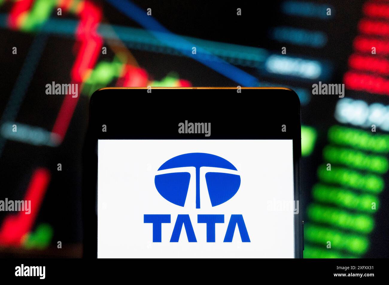 Cina. 21 giugno 2024. In questa illustrazione fotografica, il logo del conglomerato automobilistico multinazionale indiano Tata (NSE: TATAMOTORS) visualizzato su uno smartphone con un grafico indice di borsa economica sullo sfondo. (Foto di Budrul Chukrut/SOPA Images/Sipa USA) *** esclusivamente per notizie editoriali *** credito: SIPA USA/Alamy Live News Foto Stock