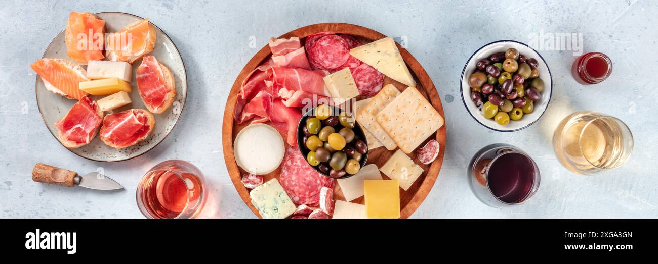 Antipasti italiani o tapas spagnole. Piatto gourmet di carne fredda e formaggi su un tavolo, shot dalla cima con vino. Una varietà di antipasti. Foto Stock