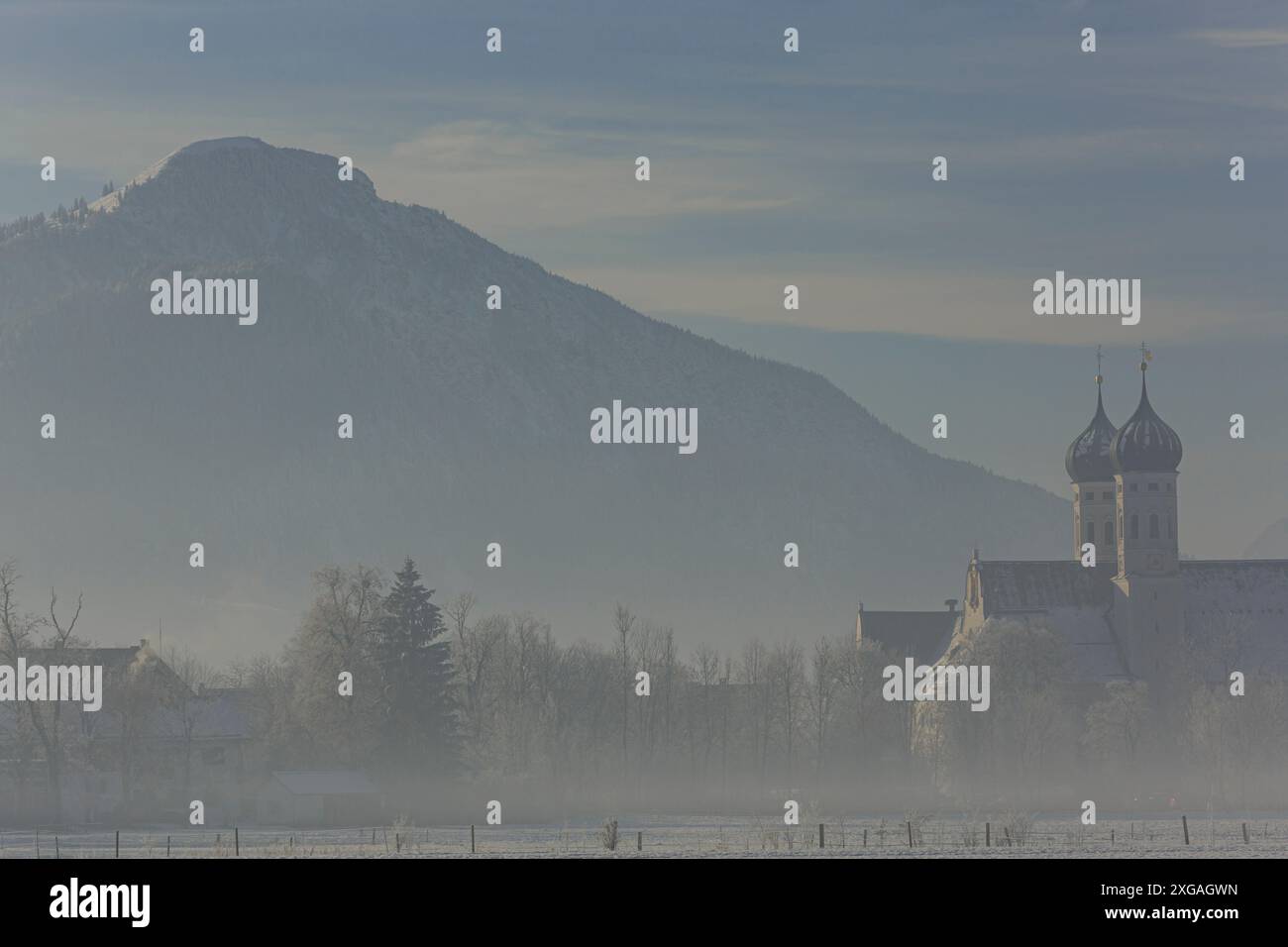 Monastero alla luce del mattino di fronte alle montagne, inverno, monastero Benediktbeuern, Baviera, Germania, Europa Foto Stock
