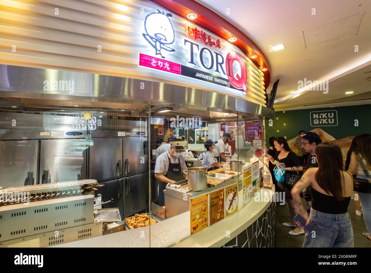 Coda all'outlet Torqi-Q, un negozio di yakitori giapponesi a Bugis Junction. Le persone fanno la fila durante l'ora di pranzo per acquistare il loro pasto. Singapore. Foto Stock