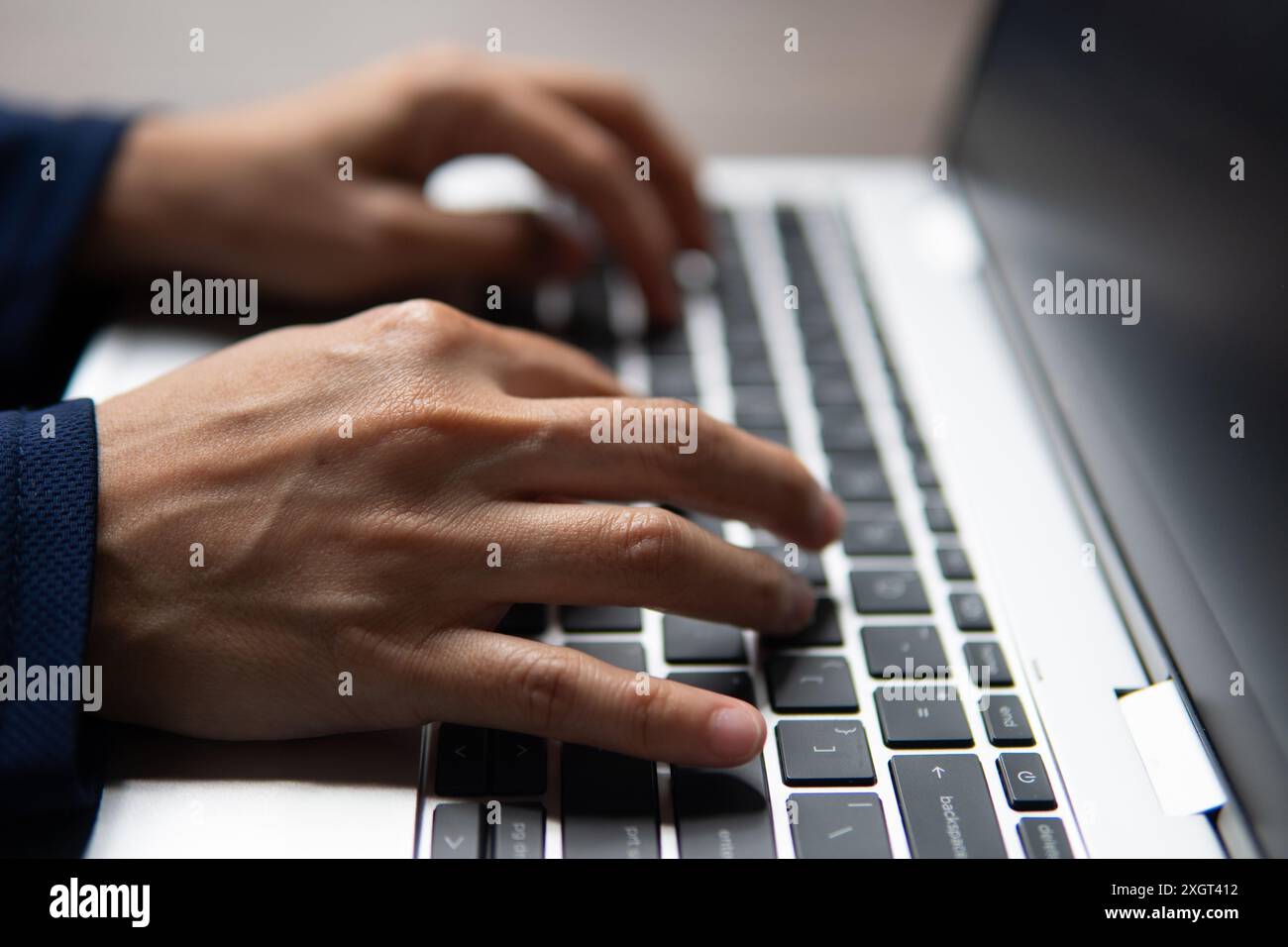 Immagine ravvicinata delle mani di una persona che digita sulla tastiera di un notebook. Concetto di produttività, produttività e lavoro. Foto Stock