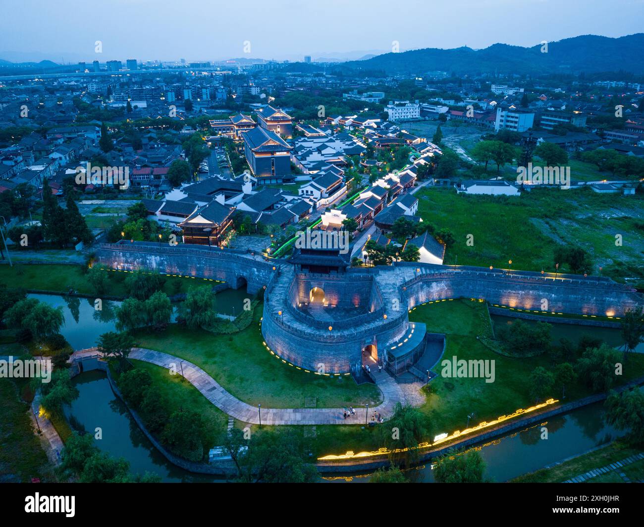 Ningbo. 10 luglio 2024. Una foto aerea scattata il 10 luglio 2024 mostra una vista notturna nell'antica contea di Cicheng nella città di Ningbo, nella provincia dello Zhejiang della Cina orientale. L'antica contea di Cicheng vanta una storia di 1.200 anni, dove edifici e strutture antiche coprono oltre 600.000 metri quadrati. Negli ultimi anni, la contea ha potenziato la sua economia turistica sfruttando i patrimoni culturali locali con servizi di accoglienza e ristorazione. La contea ha ricevuto circa 2,76 milioni di visitatori nel 2023. Crediti: Jiang Han/Xinhua/Alamy Live News Foto Stock