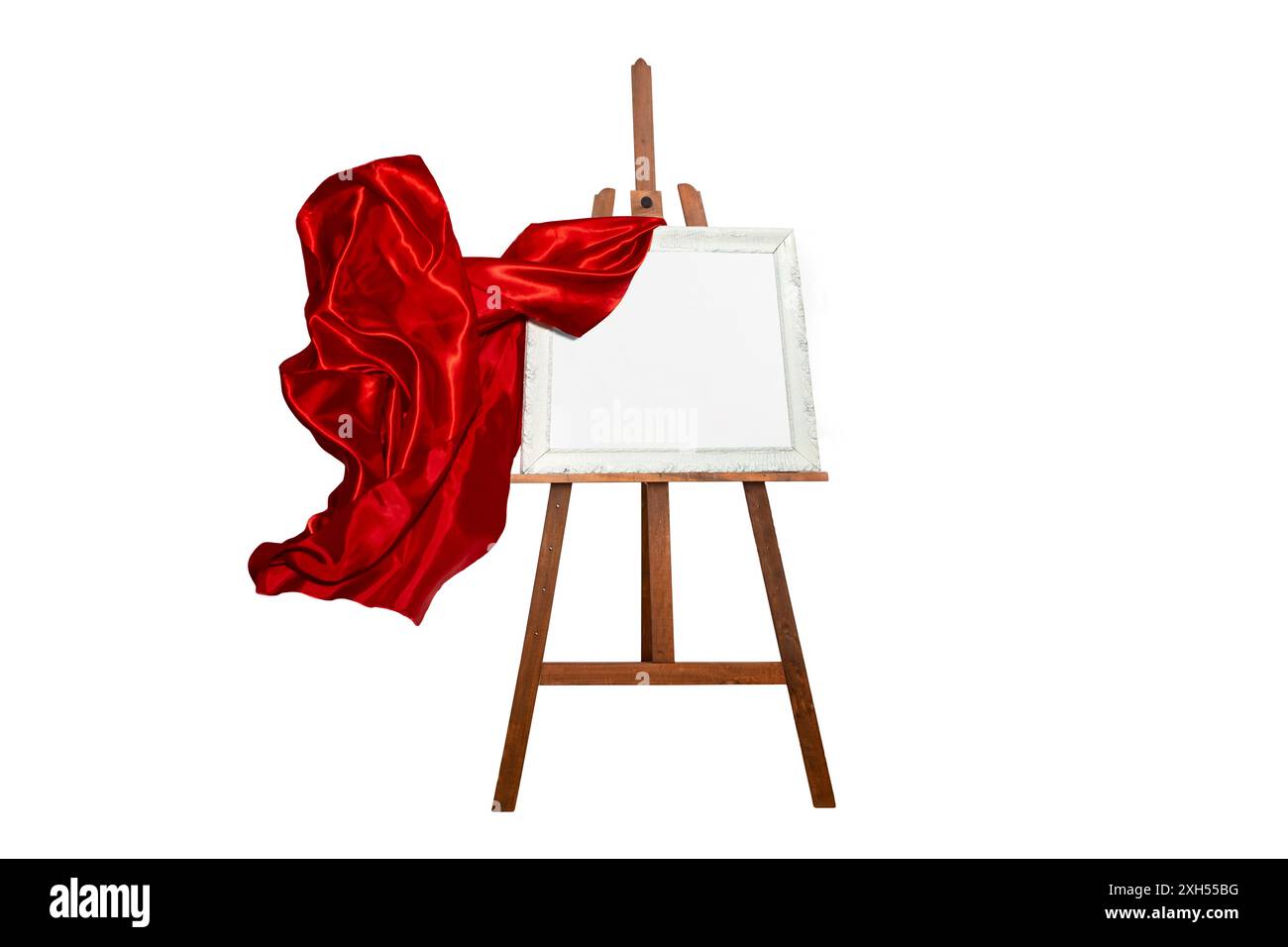 Panno satinato rosso che presenta un cavalletto in legno con una cornice bianca vuota, isolato Foto Stock