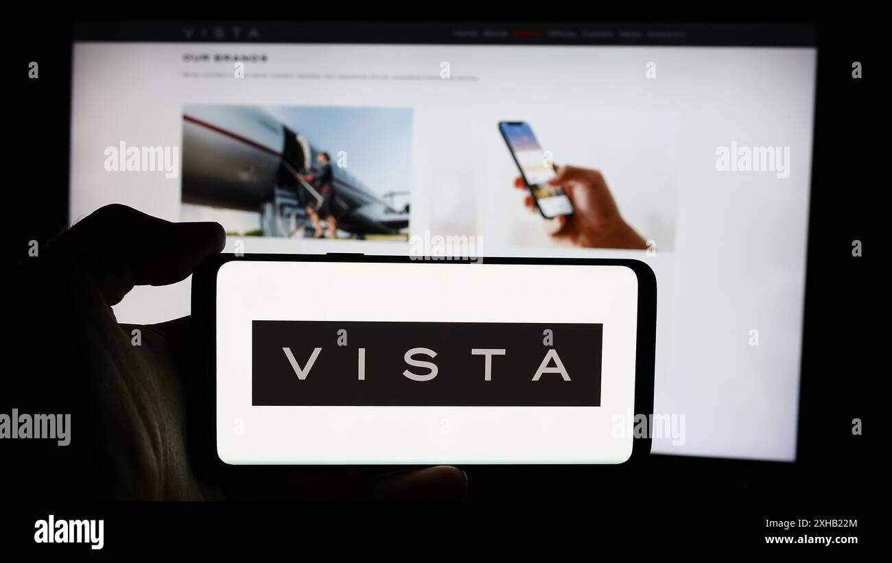 Persona che detiene un cellulare con il logo della società aeronautica degli Emirati Vista Global Holding Limited davanti alla pagina web aziendale. Mettere a fuoco il display del telefono. Foto Stock