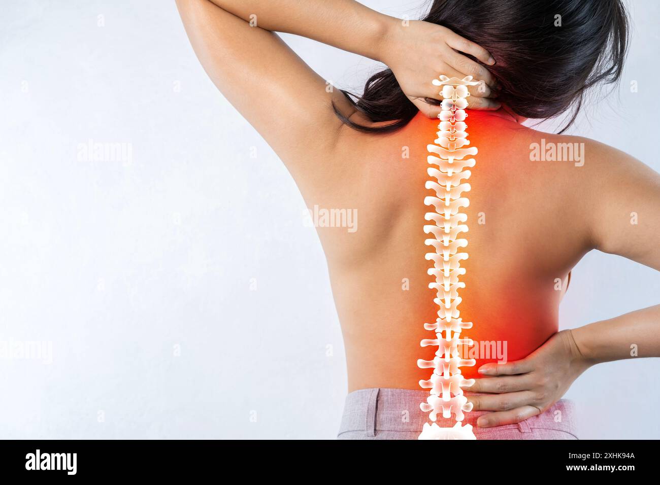 Donna che sfrega dolori alla schiena. Giovani donne che gli tengono il collo in dolore. Concetto medico. Dolore ai reni. Malato in una donna dal lavoro sedentario. La persona soffre Foto Stock