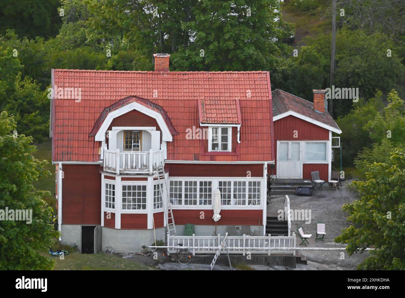 Die Schären vor Stockholm. Blick auf das ehemalige Sommerhaus von Astrid Lindgren Stenhällen auf der Schäreninsel Furusund. Die Insel War früher ein Kurort für wohlhabende Stockholmer Der Stockholmer Schärengarten besteht aus ungefähr 30 000 Inseln, Schären und Felsen, die sich 80 km östlich vom Stadtzentrum in die Ostsee erstrecken. Einige sind große, bewohnte Inseln, die für ihre lebhaften Sommerpartys bekannt sind, andere ähneln eher felsigen Außenposten oder Gras bewachsenen Kuppen, die von Seehunden oder Kajakfahrern okkupiert werden. Stoccolma Schweden *** l'arcipelago al largo di Stoccolma vi Foto Stock