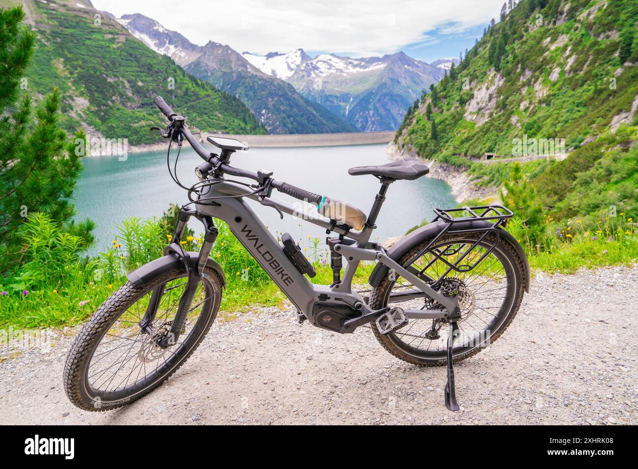 Bicicletta in piedi su un sentiero escursionistico con vista sul lago e sulle montagne circostanti in natura, Klein Tibet, Zillertal, Austria Foto Stock