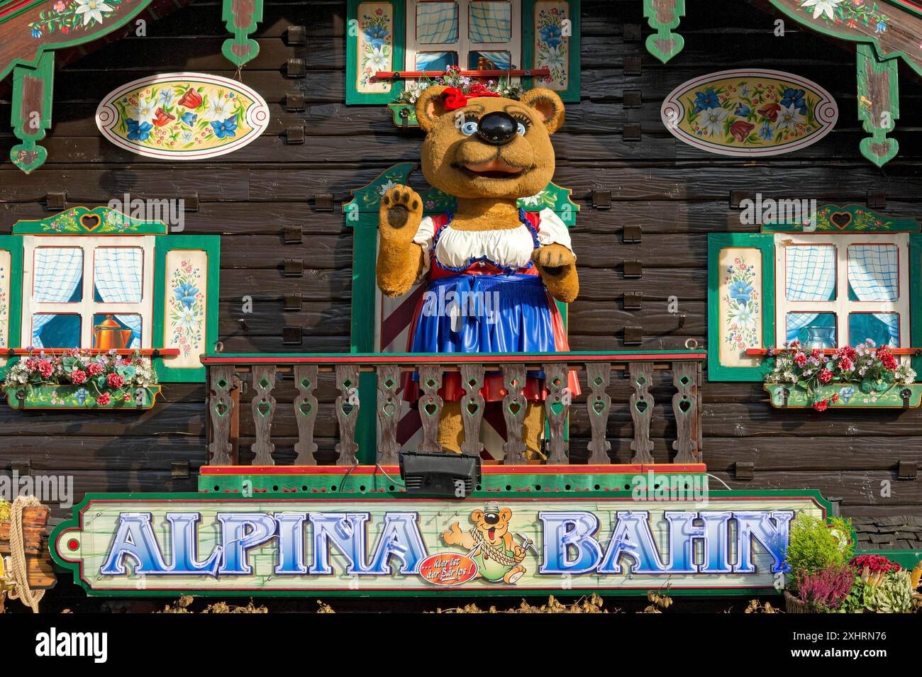 Rifugio di montagna con orsacchiotto in tradizionale costume tradizionale, statuetta di orso, decorazione delle montagne russe Alpinabahn al Wies'n Foto Stock