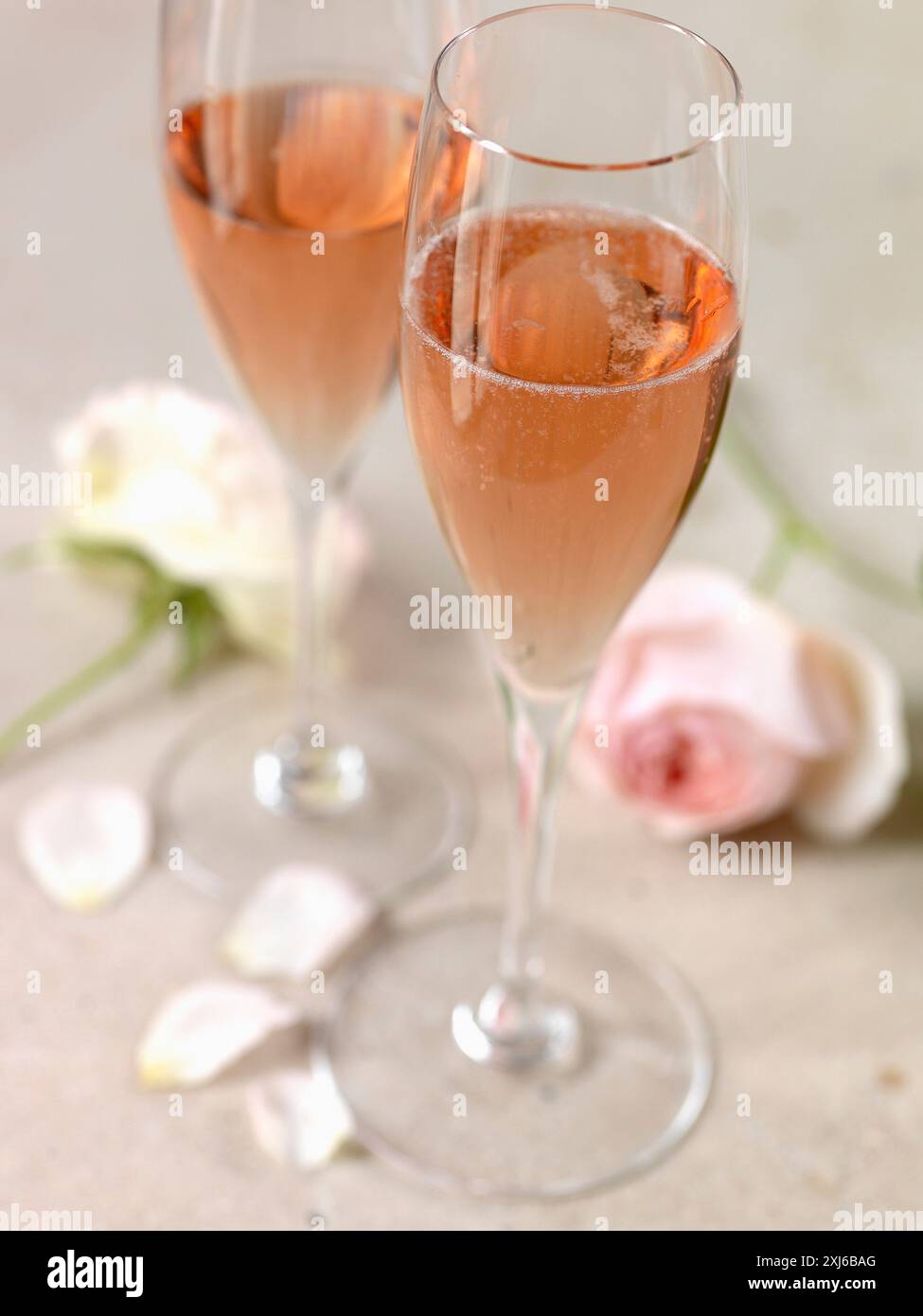 Bicchieri di champagne rosé e rose Foto Stock