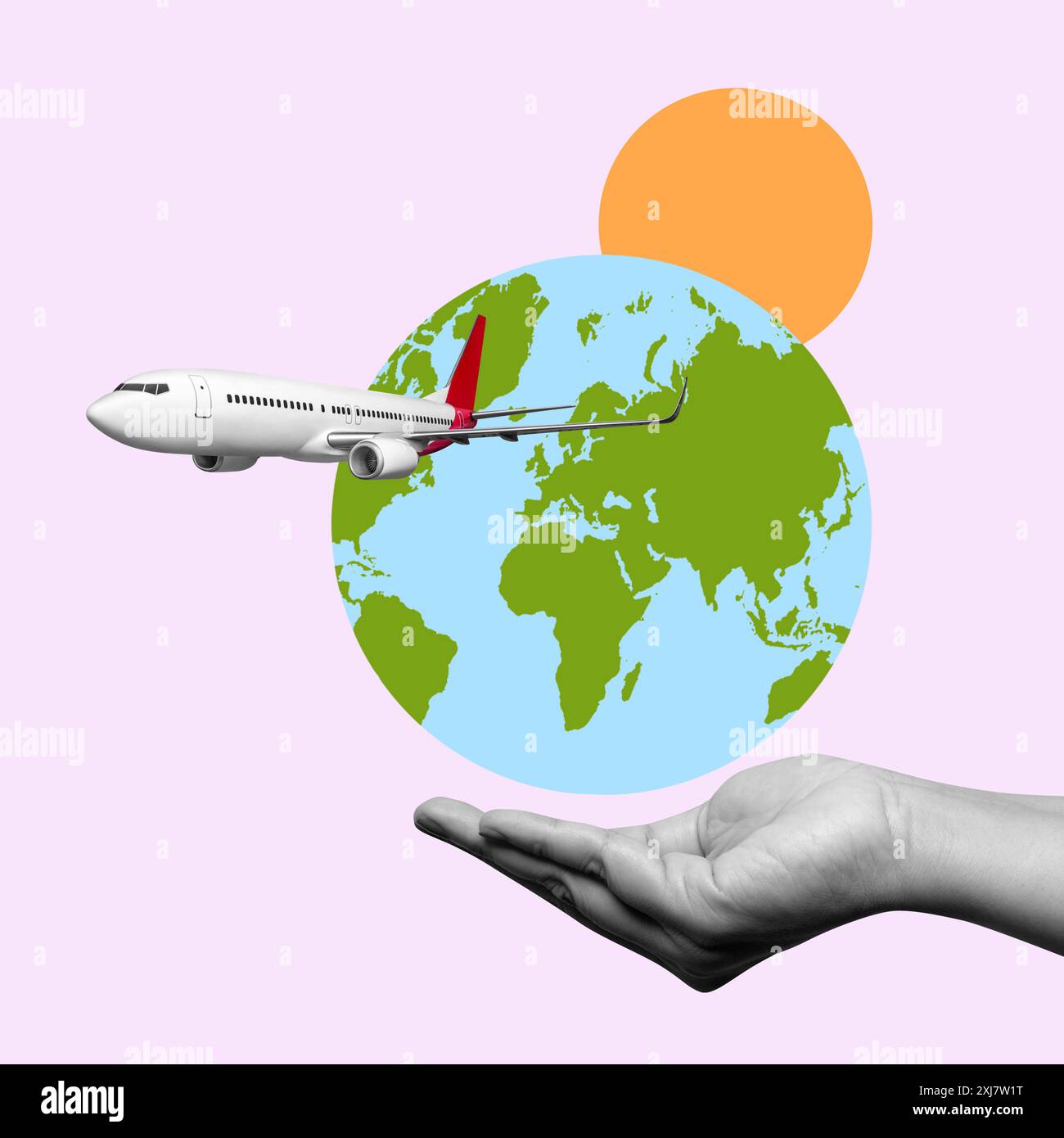 Una mano sta tenendo un aereo bianco davanti a un globo. Concetto di viaggio e avventura, così come l'emozione di esplorare nuovi luoghi. La b rosa Foto Stock