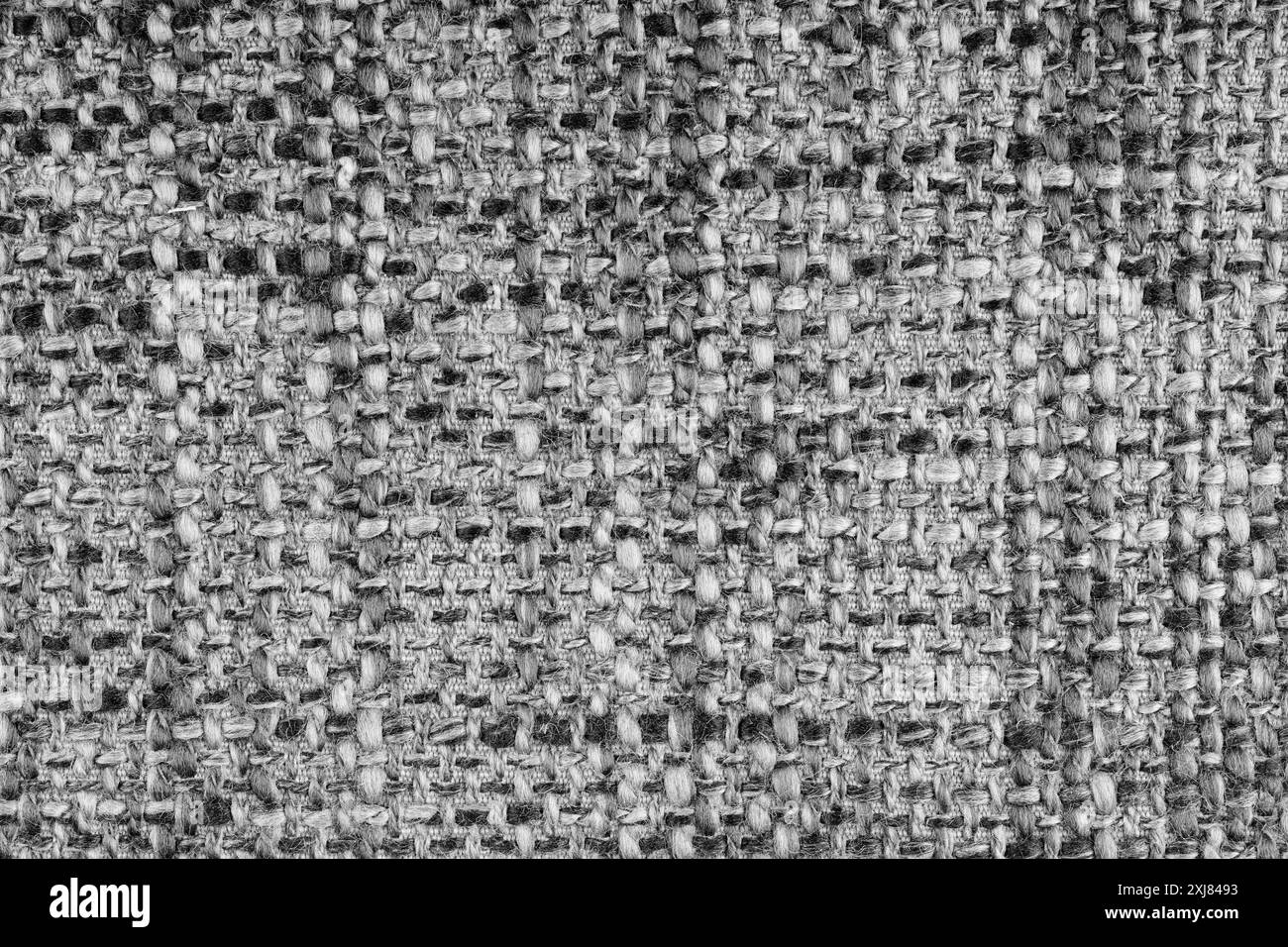 Trama in jacquard grigio con trama ruvida macro, primo piano. Panno melange di colore misto. Materiale per tessuti per la casa, tappezzeria e decorazioni per tende, g Foto Stock