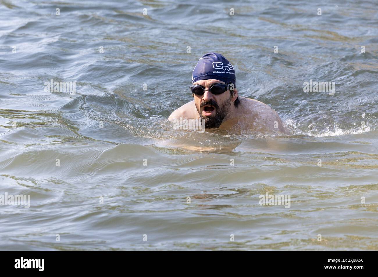 Le persone che nuotano nella Senna, a Parigi il 17 luglio 2024, dopo che il sindaco di Parigi nuota nel fiume per dimostrare che è abbastanza pulito da ospitare gli eventi di nuoto all'aperto alle Olimpiadi di Parigi alla fine di questo mese. Nonostante un investimento di 1,4 miliardi di euro (1,5 miliardi di dollari) per prevenire perdite di acque reflue nel corso d'acqua, la Senna ha causato sospetti in vista dell'apertura dei Giochi di Parigi del 26 luglio, dopo aver ripetutamente fallito i test di qualità dell'acqua. Ma dall'inizio di luglio, con forti piogge che finalmente lasciano il posto al sole, alcuni campioni hanno mostrato che il fiume è pronto per l'apertura. Foto Stock