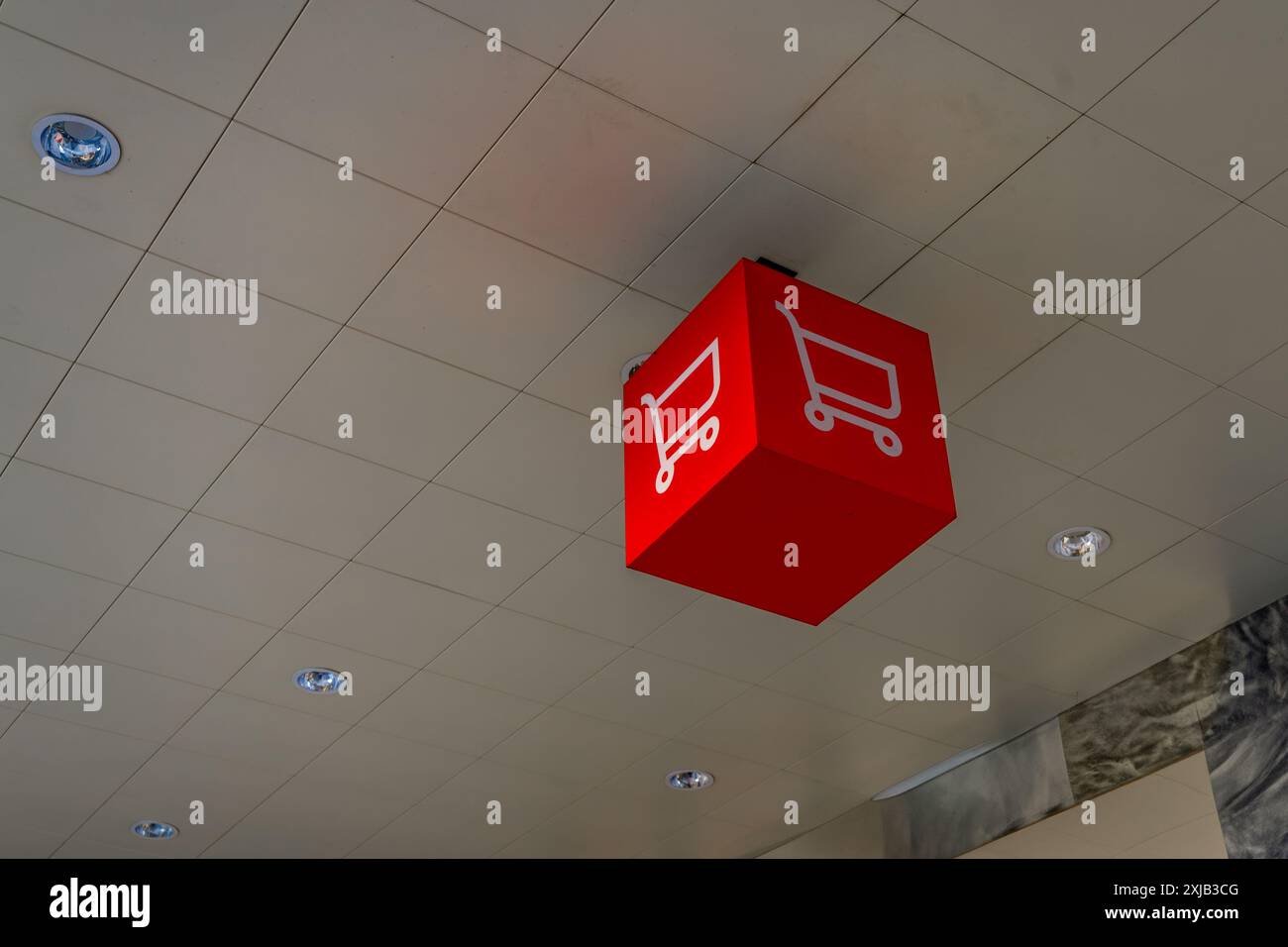 Aggiungi al carrello banner pubblicitario rosso con carrello in ipermercato Foto Stock