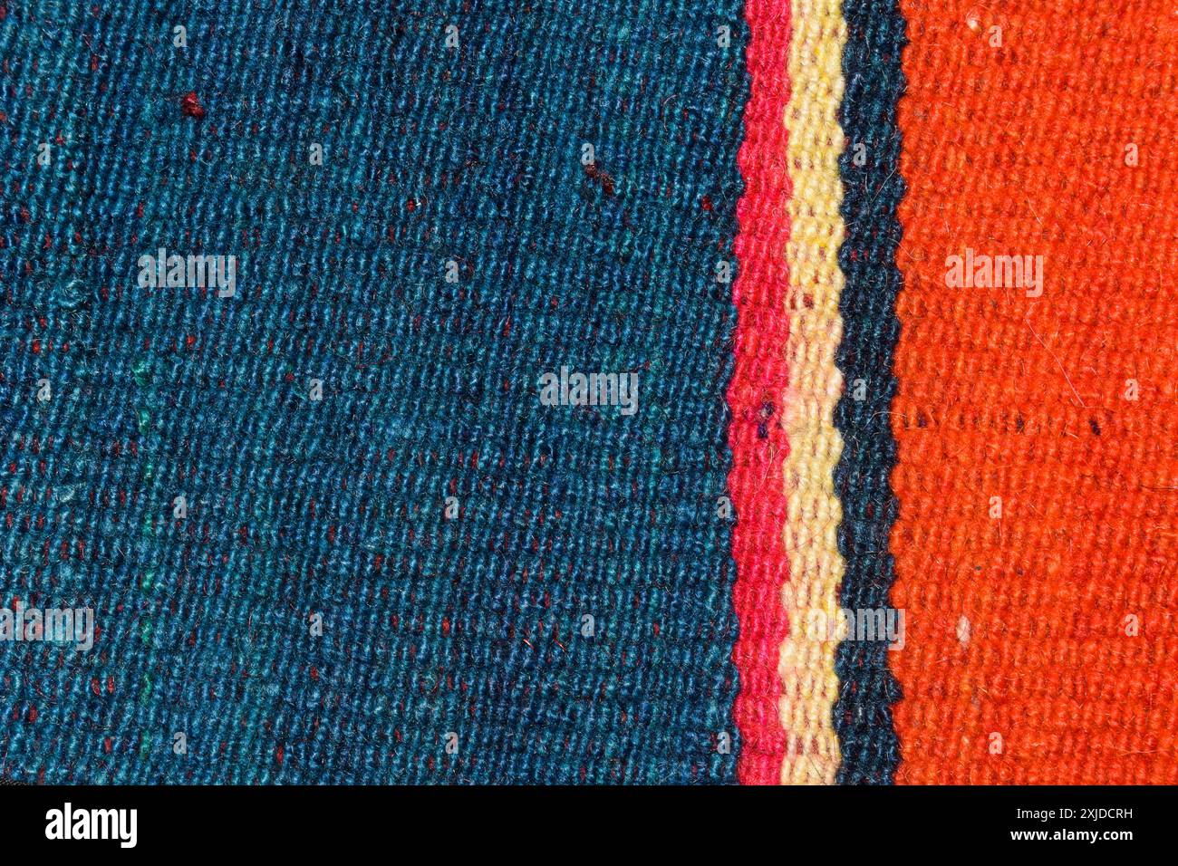 Strisce colorate blu, rosse, gialle e arancioni sui tessuti Foto Stock