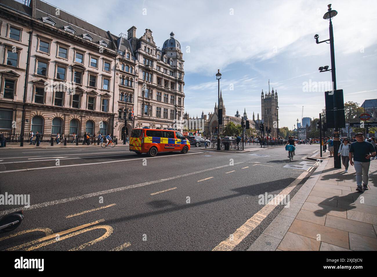 Londra, Regno Unito - 09 ottobre 2023 : Un furgone rosso e blu della polizia percorre una strada di Londra con pedoni e ciclisti a piedi e in bicicletta nelle vicinanze. L'ho Foto Stock Londra, Regno Unito - 09 ottobre 2023 : Un furgone rosso e blu della polizia percorre una strada di Londra con pedoni e ciclisti a piedi e in bicicletta nelle vicinanze. L'ho Foto Stock