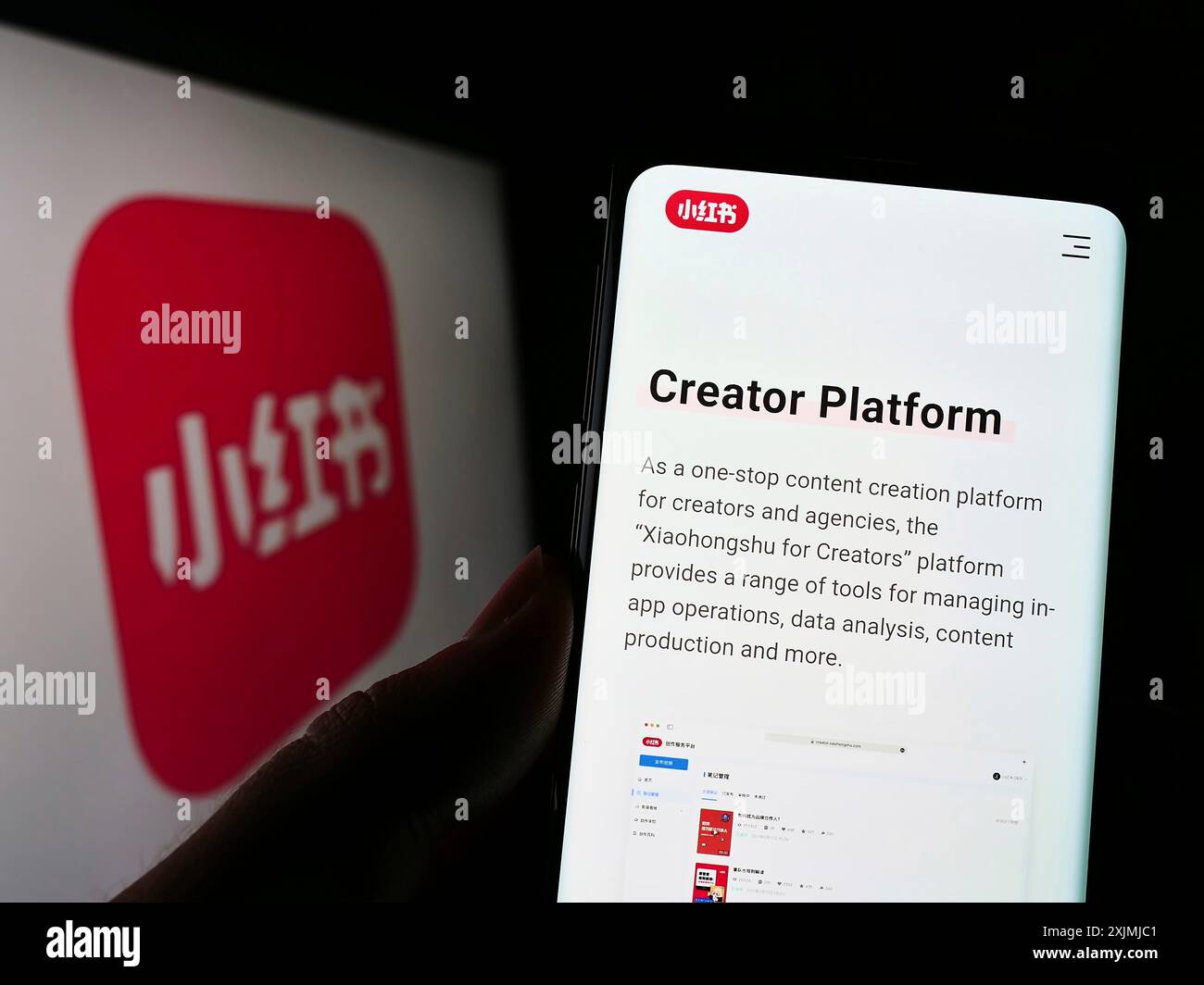 Stoccarda, Germania, 07-30-2022: Persona che tiene il cellulare con pagina web della società cinese di social media Xiaohongshu sullo schermo davanti al logo. Concentrati Foto Stock