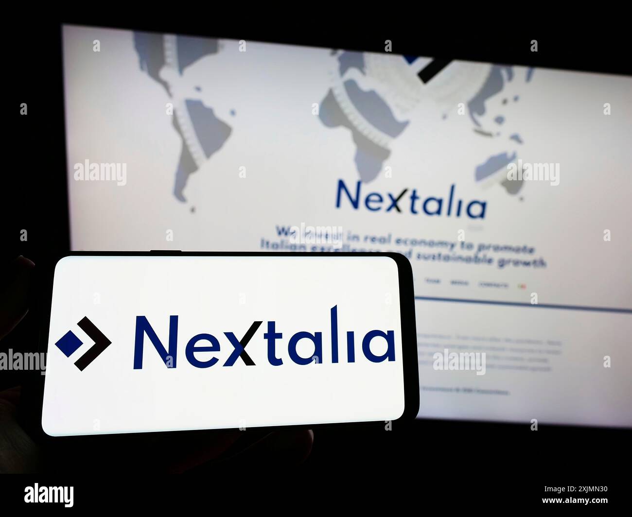 Stoccarda, Germania, 09-10-2022: Persona che detiene uno smartphone con logo della società di investimento italiana Nextalia SGR S.p.A. sullo schermo di fronte al sito web. Foto Stock