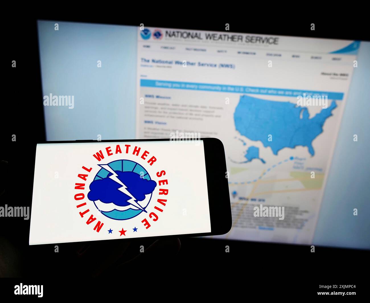Stoccarda, Germania, 09-30-2022: Persona che tiene un cellulare con il logo dell'agenzia statunitense National Weather Service (NWS) sullo schermo davanti alla pagina web. Concentrati Foto Stock
