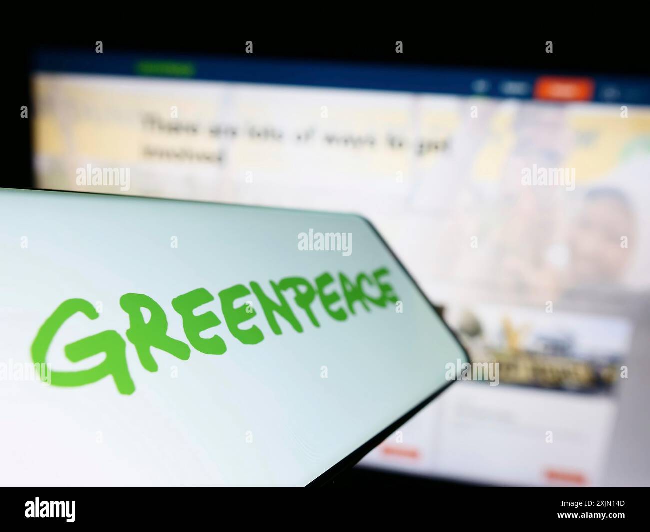 Stoccarda, Germania, 01-26-2023: Telefono cellulare con logo della rete di campagne ambientali Greenpeace sullo schermo di fronte al sito web. Concentrati a sinistra Foto Stock