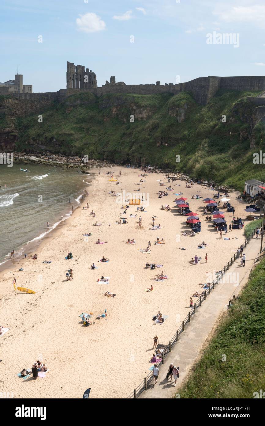 Persone che amano il sole estivo sulla spiaggia di King Edward's Bay, a Tynemouth, Inghilterra, Regno Unito Foto Stock