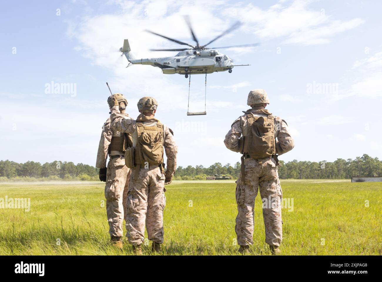 US Marines con 2nd Distribution Support Battalion, Combat Logistics Regiment 2, 2nd Marine Logistics Group, osserva come il fascio pesante attaccato viene spostato durante le operazioni del team di supporto elicotteri presso Tactical Landing zone Condor a Camp Lejeune, Carolina del Nord, 18 luglio 2024. Il 2° DSB ha condotto l'addestramento per preparare i Marines a gestire le attività nelle zone di atterraggio; facilitare il prelievo, il movimento e l'atterraggio di truppe, equipaggiamenti e rifornimenti trasportati da elicotteri. (Foto del corpo dei Marines degli Stati Uniti di Lance Cpl. Franco Lewis) Foto Stock