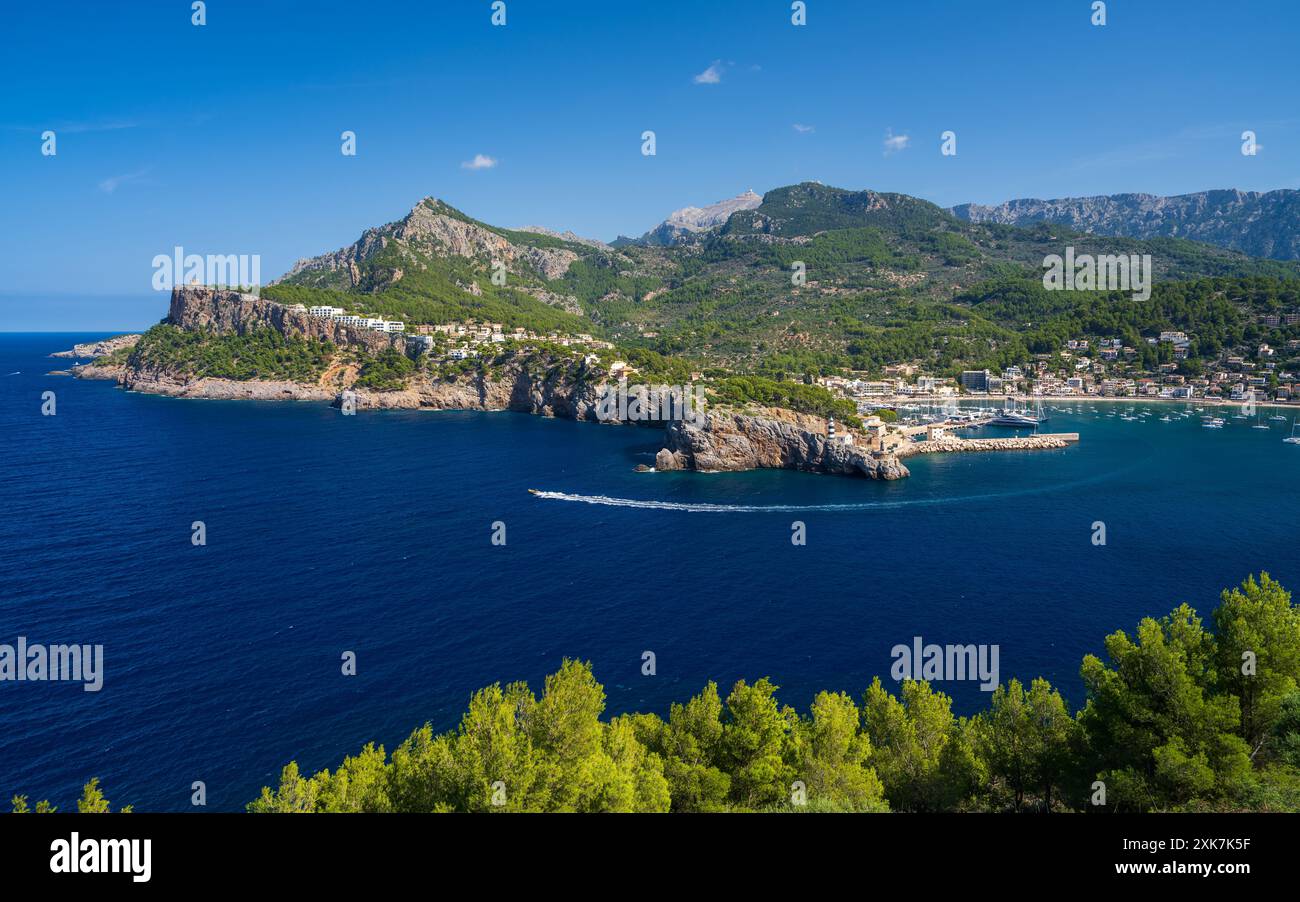 Una barca turistica naviga rapidamente oltre la costa. Vista panoramica di Port de Soller, Palma di Maiorca, Spagna. Popolare località turistica di Maiorca. Foto Stock