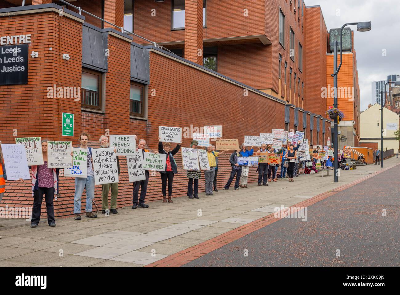 Leeds, Regno Unito. 22 LUGLIO 2024. Numerosi attivisti tengono cartelli fuori dalla Corte Corona di Leeds a seguito della condanna dell'attivista di Axe Drax Karen "Coffee" Wildin riguardo a una parte di protesta in cui un treno verso la Drax powerstation è stato fermato. All'attivista è stato concesso un discarico condizionale e ha dovuto pagare le tasse del tribunale. Credito Milo Chandler/Alamy Live News Foto Stock