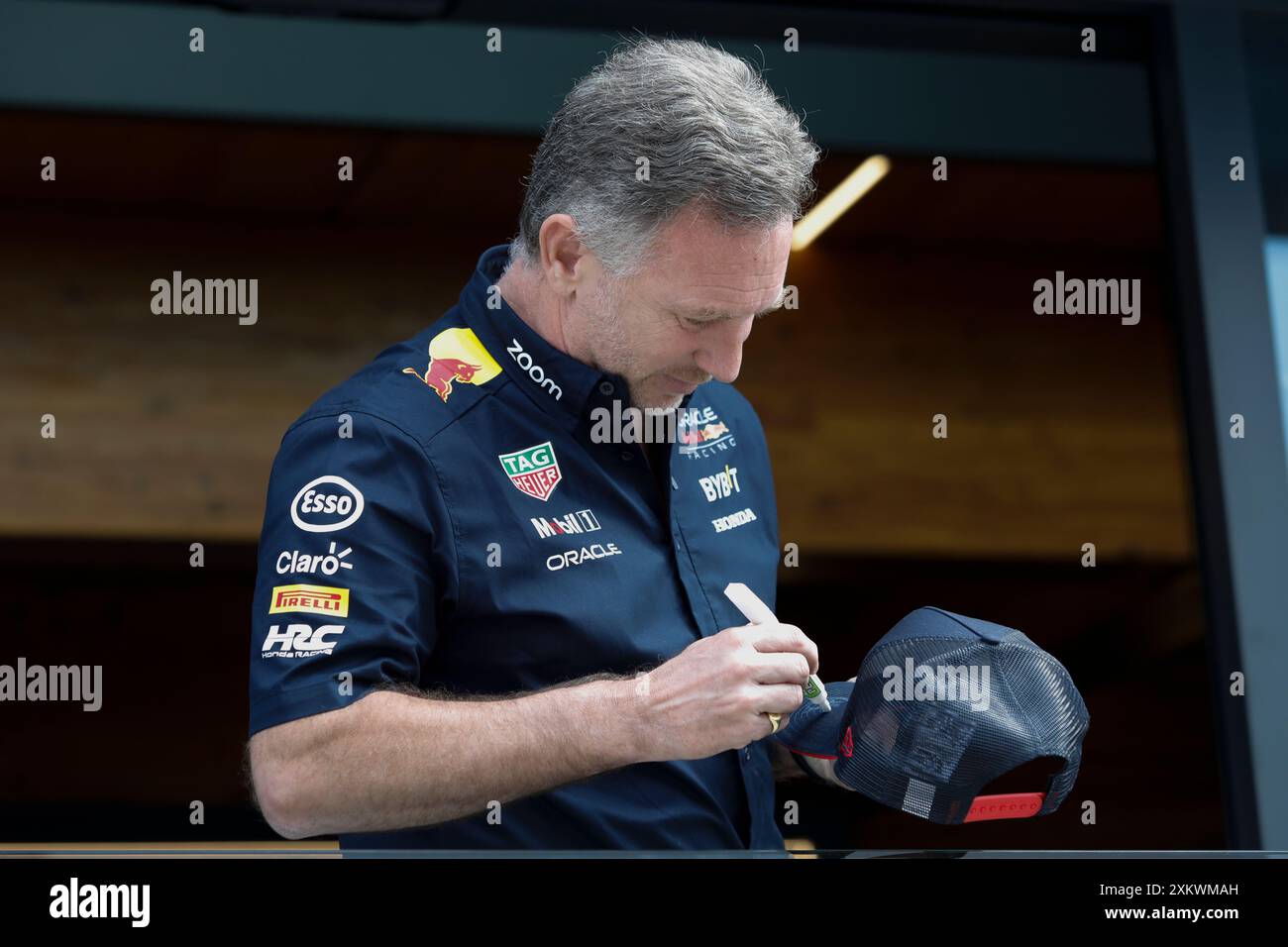 Mogyorod, Ungheria. 20 luglio 2024. Formula 1 Gran Premio d'Ungheria a Hungaroring, Ungheria. Nella foto: Christian Horner, team principal di Oracle Red Bull Racing, firma un cappellino da baseball per fan © Piotr Zajac/Alamy Live News Foto Stock