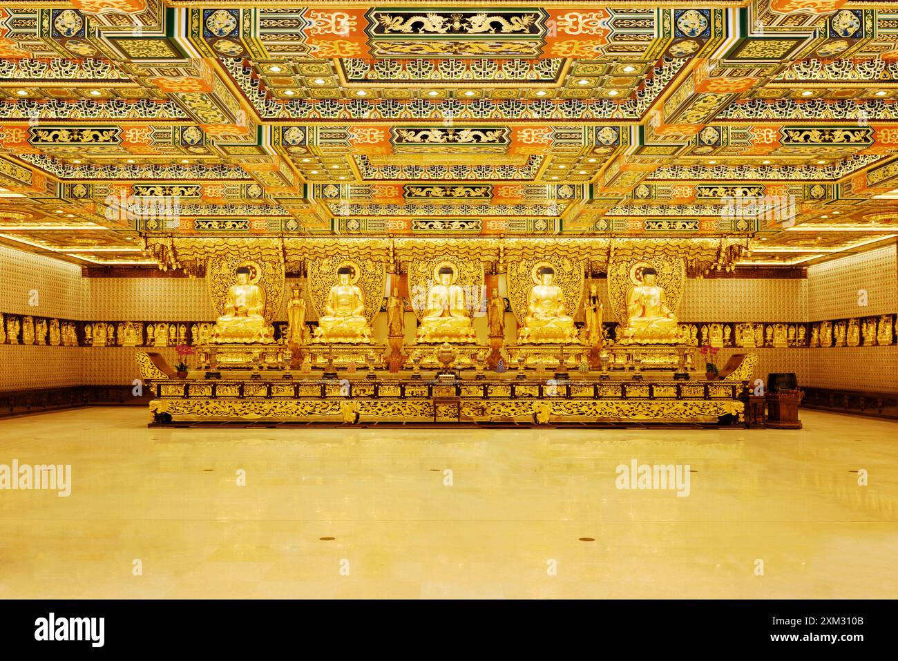 Statue del Buddha d'oro all'interno del tempio di po Lin Monas Foto Stock