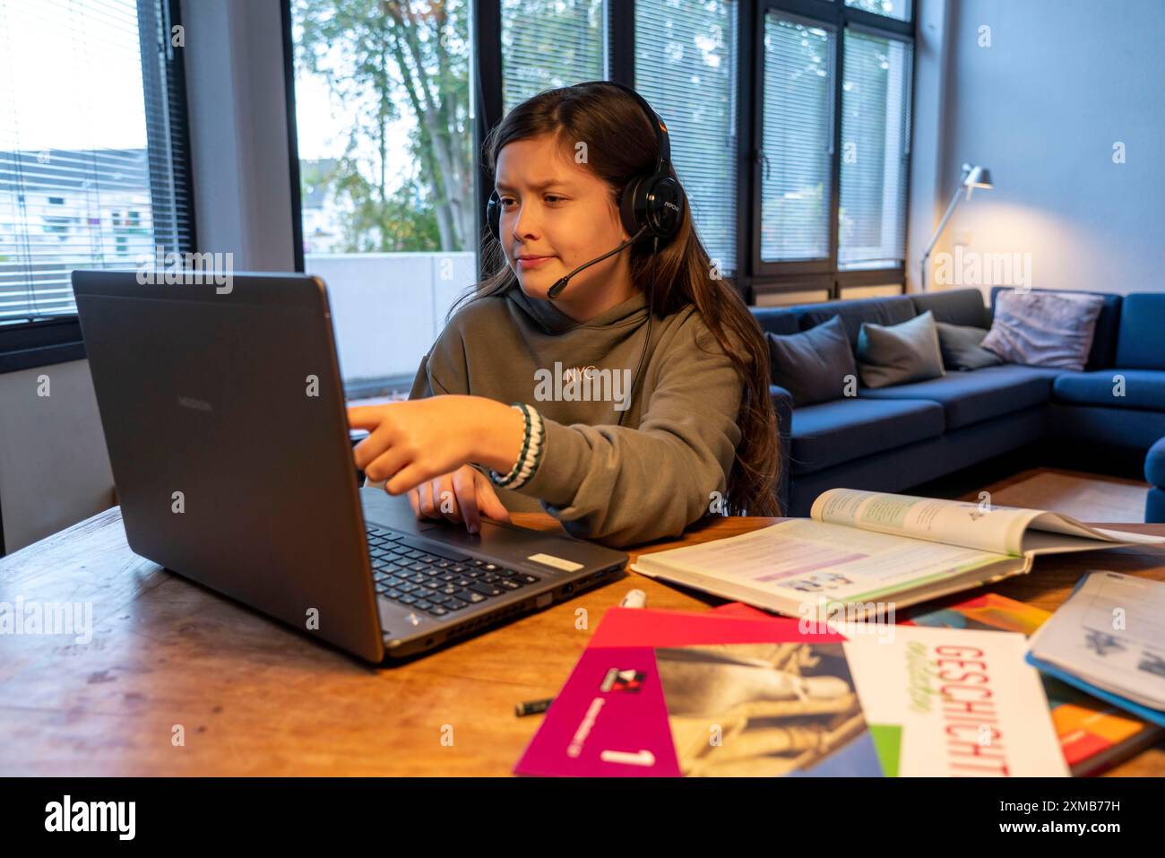 Homeschooling, ragazza, 11 anni, impara a casa, a casa, lezioni a casa, apprendimento a distanza, chat con insegnanti e compagni di classe tramite laptop Foto Stock