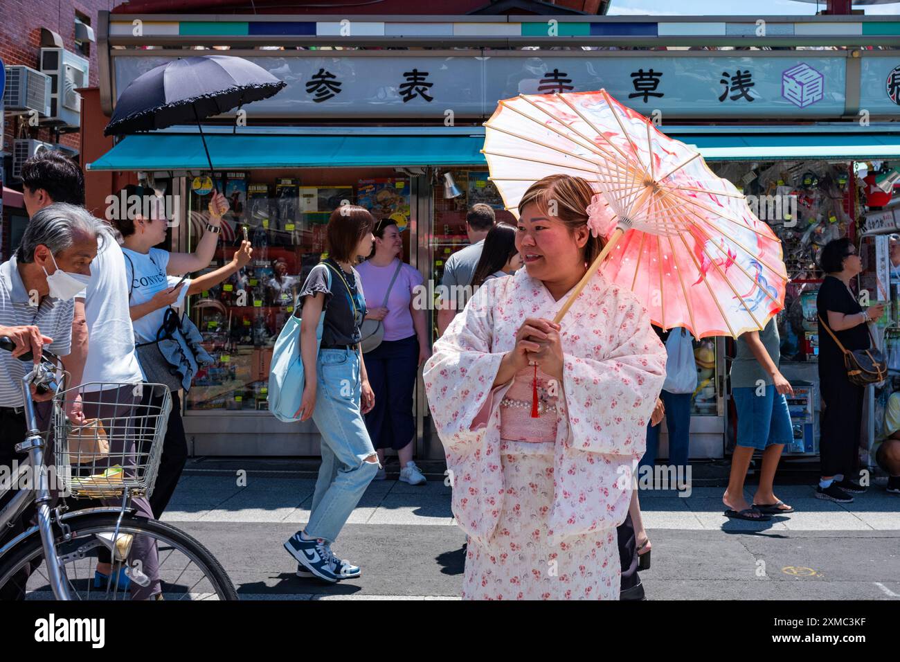 Tokyo, Giappone - 15 giugno 2024: Una donna indossa un kimono mentre visita Nakamise, la strada dello shopping più famosa di Asakusa, vicino al tempio senso-Ji, Tokyo Foto Stock