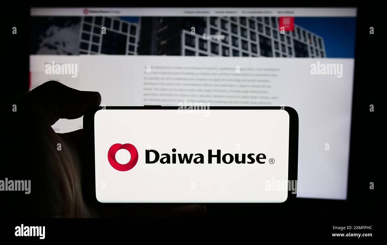 Persona che detiene un cellulare con il logo della società di costruzioni Daiwa House Industry Co. Ltd. Di fronte alla pagina Web aziendale. Mettere a fuoco il display del telefono. Foto Stock