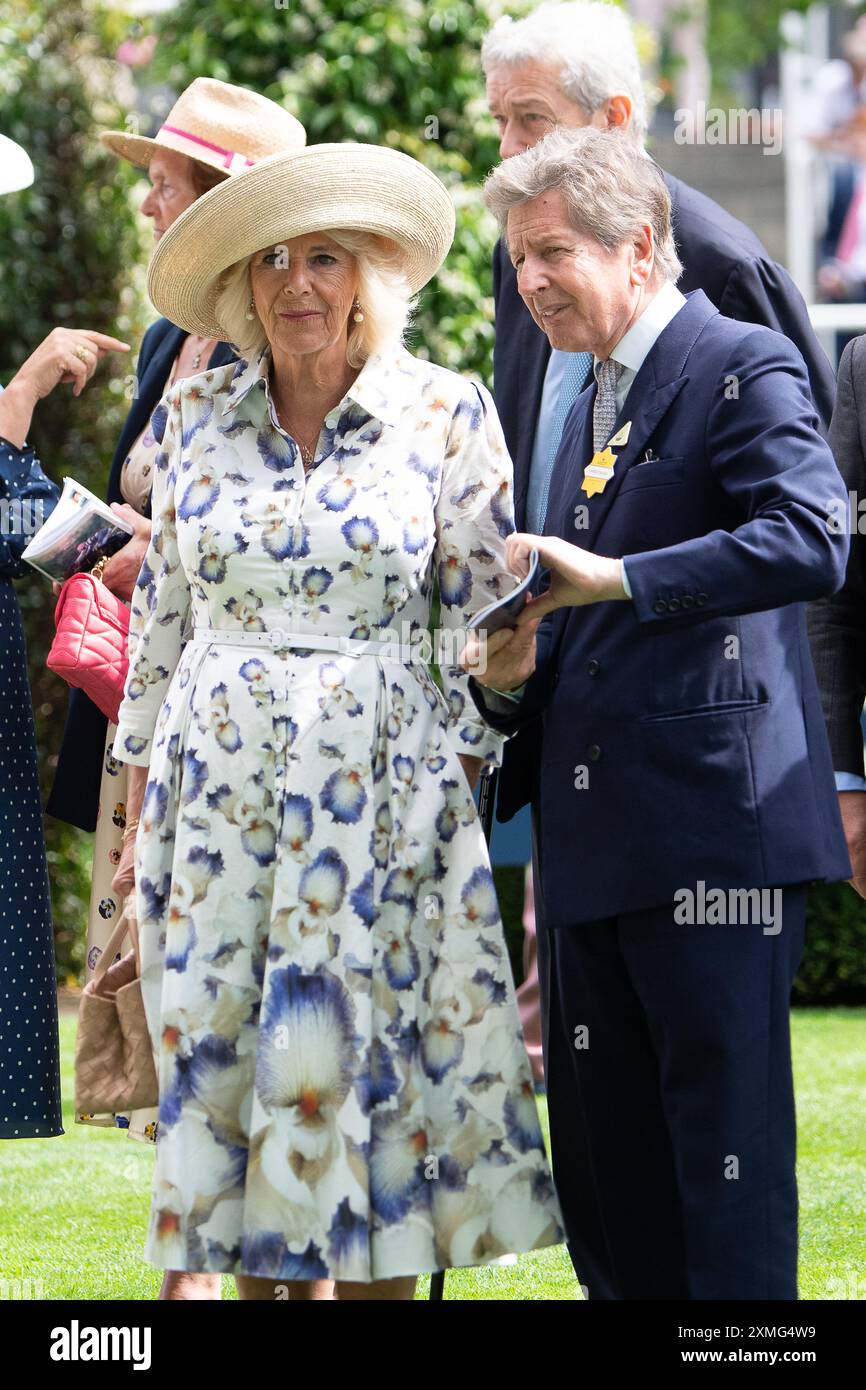 Ascot, Berkshire, Regno Unito. 28 luglio 2024. Sua Maestà la Regina Camilla con il suo manager delle corse John Warren, nell'anello della parata all'ippodromo di Ascot per il QIPCO King George Day. La regina indossava un grazioso abito estivo floreale bianco con una stampa a Iris blu della designer reale Suzannah London. Sua Maesta' indossava anche un ampio cappello a tesa e portava una piccola borsa biege. La regina Camilla indossava orecchini a goccia di perle e una collana d'oro. Crediti: Maureen McLean/Alamy Live News Foto Stock