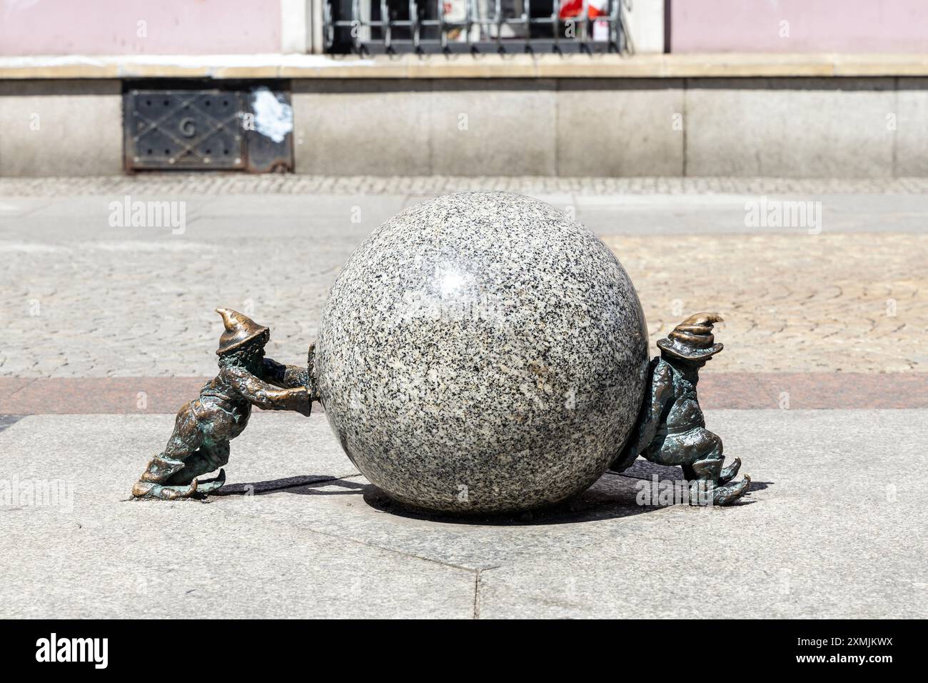 "Sisifusa" - due statuette di gnomi che spingono una sfera di pietra vicino alla piazza del mercato, alla città vecchia, a Breslavia, Slesia, Polonia Foto Stock