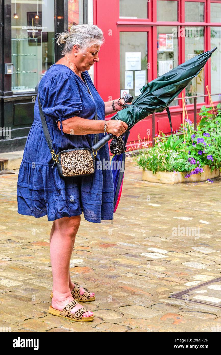 Ombrello donna di taglia superiore che inizia a piovere - Loches, Indre-et-Loire (37), Francia. Foto Stock