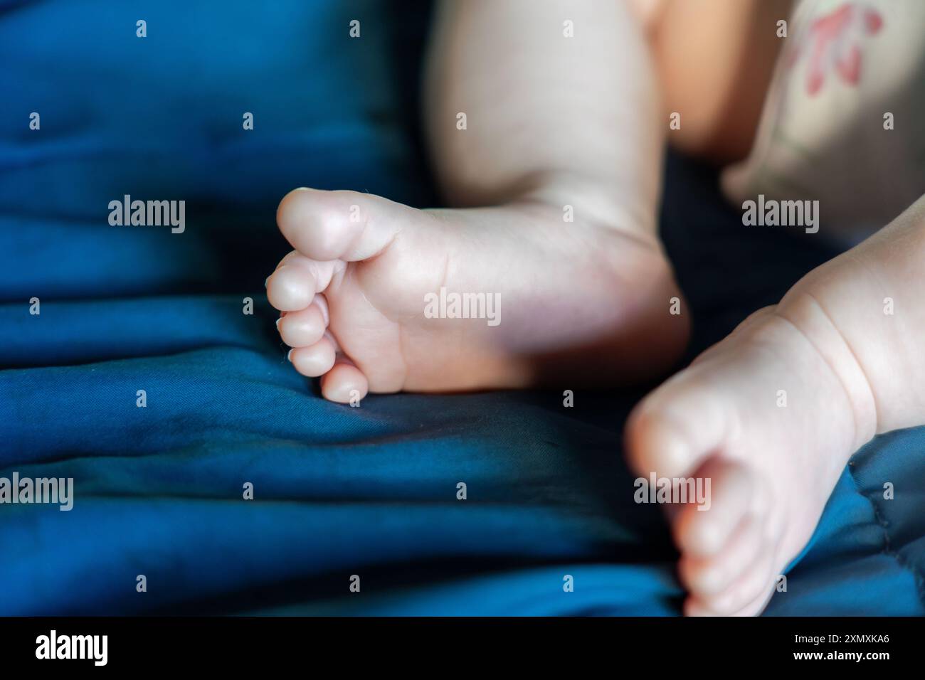 i piedi di un bambino di 2 falene con coperta blu Foto Stock