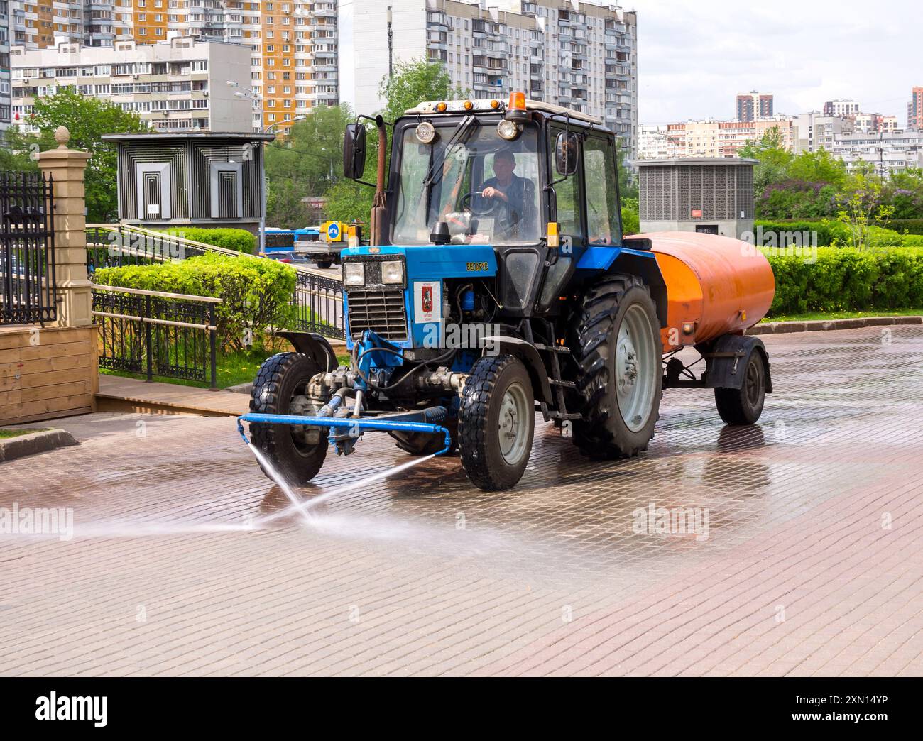 Mosca, Russia - 12 maggio 2023: Un trattore per servizi pubblici lava il marciapiede, città di Mosca Foto Stock