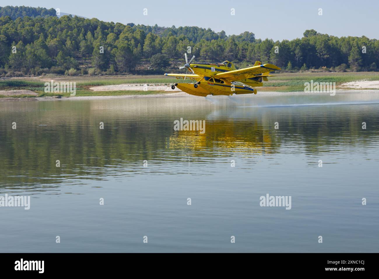 Beniarrs, Spagna, 07-31-2024; avvicinamento di un idrovolante non riconoscibile alle acque del bacino idrico di Beniarres a sostegno aereo degli incendi boschivi Foto Stock