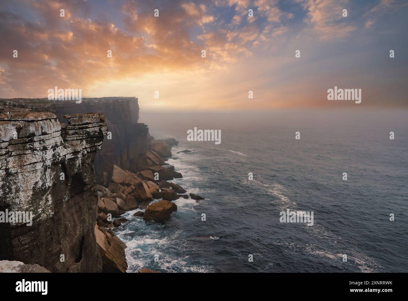 Spettacolare scogliera costiera al tramonto con formazioni rocciose robuste in Portogallo Foto Stock