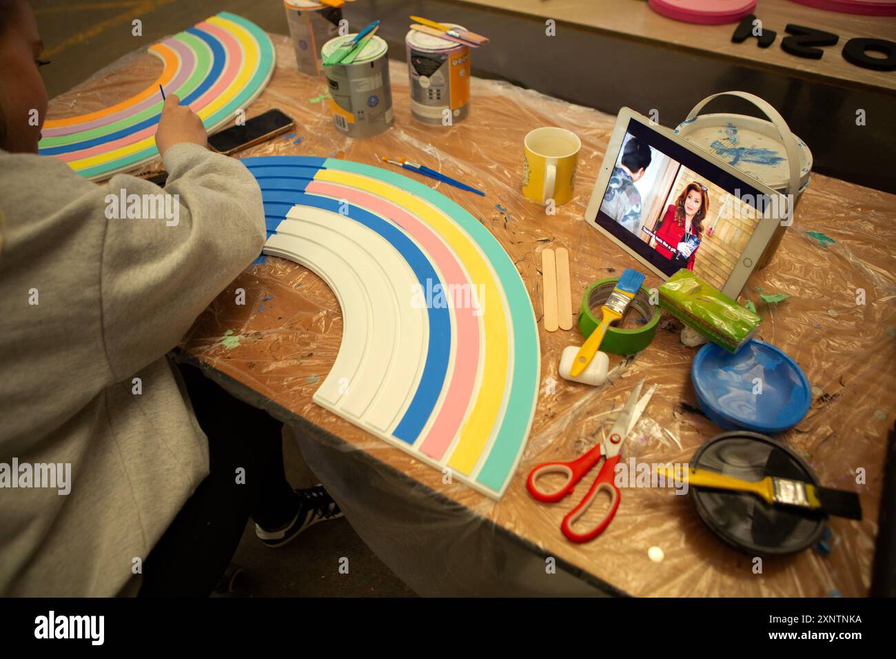 Grace Evans che sta aiutando sua madre artista Rachel Smith Evans nell'installazione dell'album "Lover" presso Make CIC che è un Workspace a Liverpool dove Foto Stock