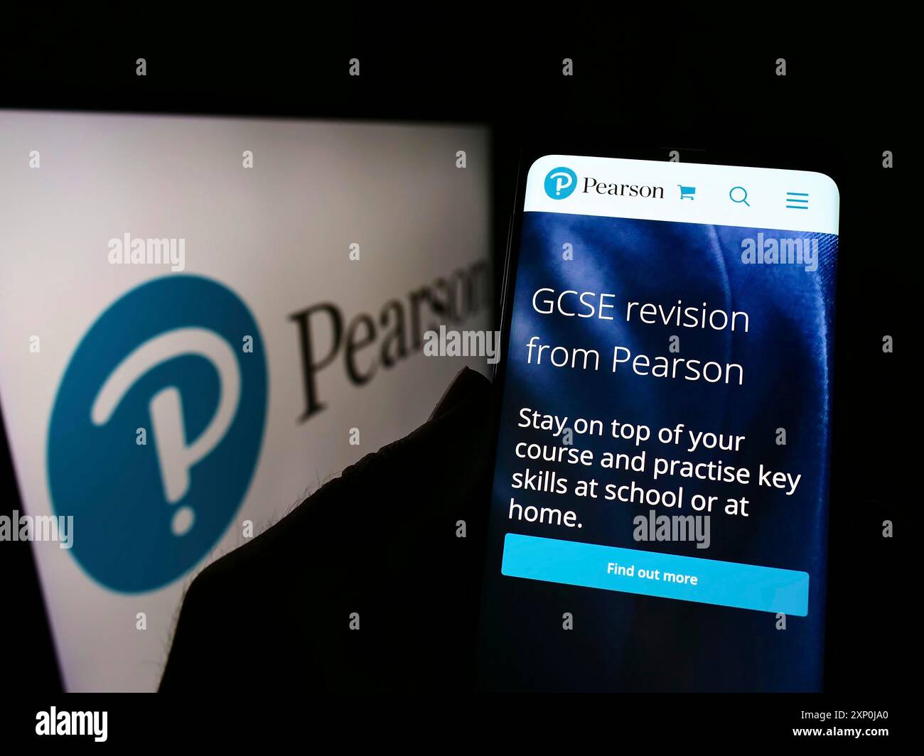 Stoccarda, Germania, 01-30-2022: Persona che detiene il cellulare con pagina web della casa editrice britannica Pearson plc sullo schermo davanti al logo. Concentrati su Foto Stock